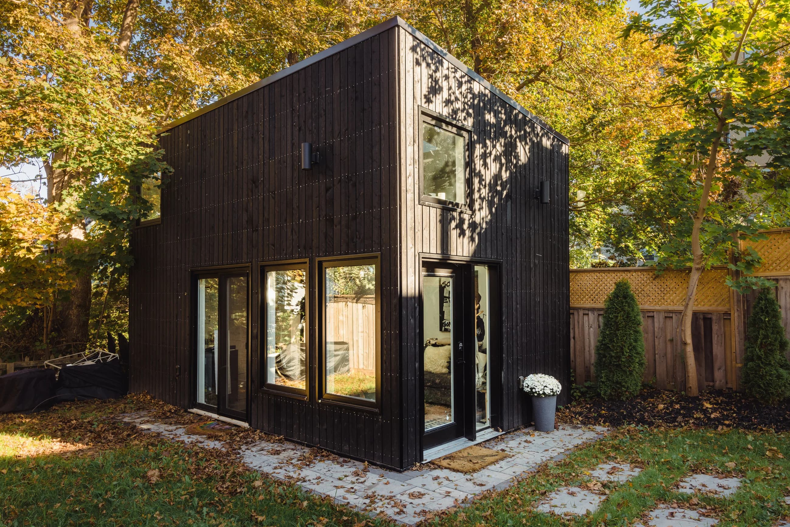 Vernon Street home with dark timber cladding beneath mature trees